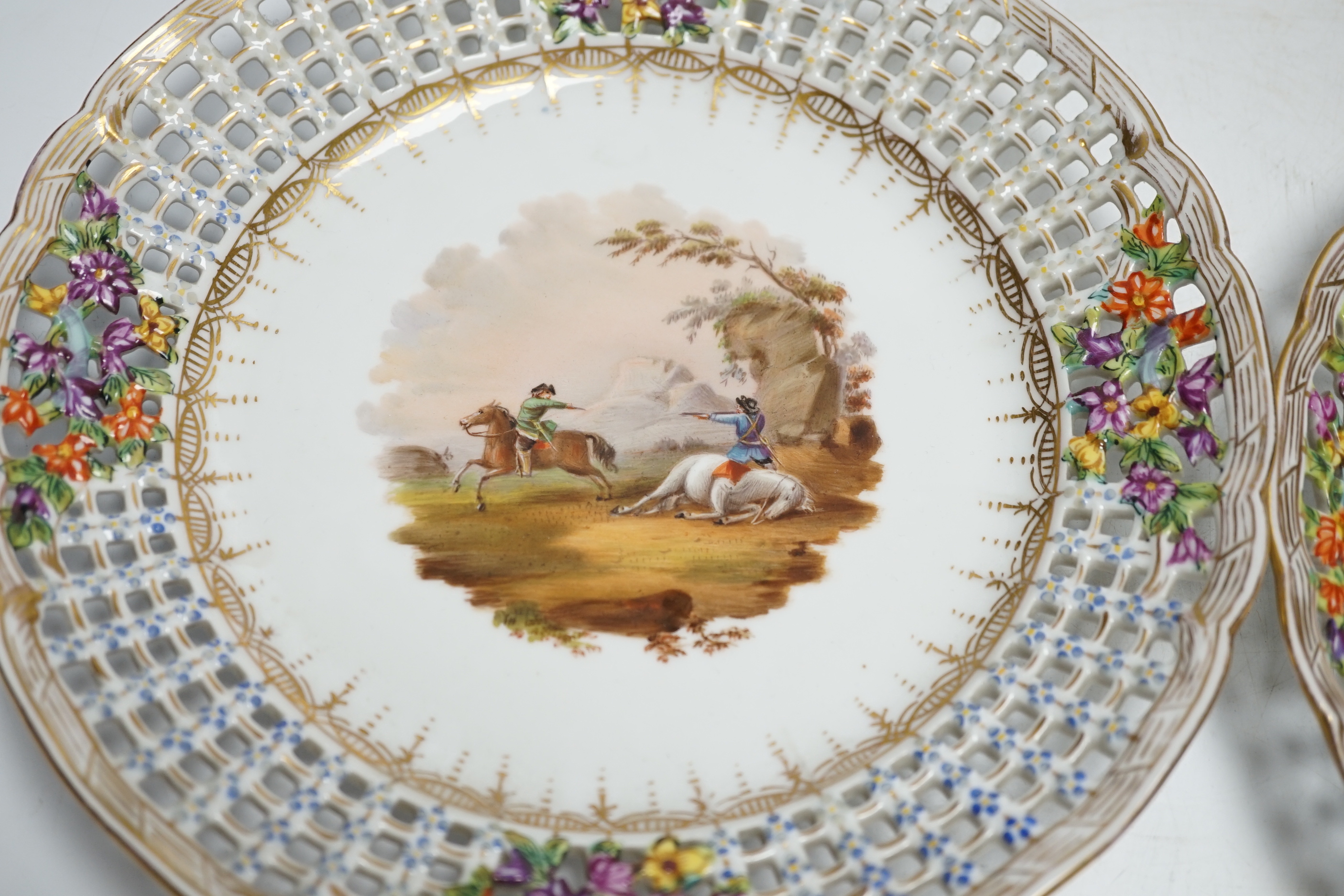 A set of four Dresden porcelain cabinet plates decorated with landscapes, 22cm diameter